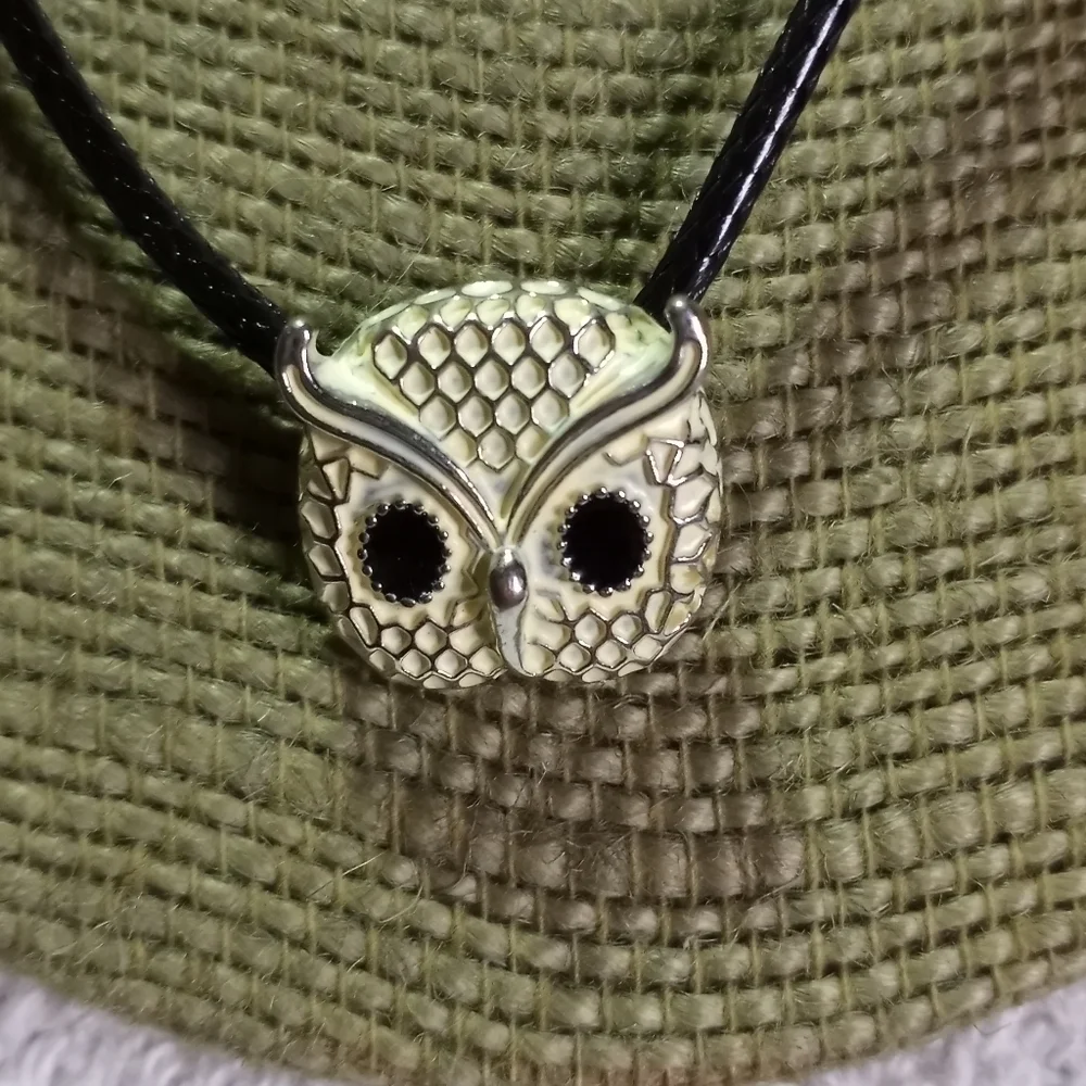 Silvertone white owl on black cord with black eyes necklace